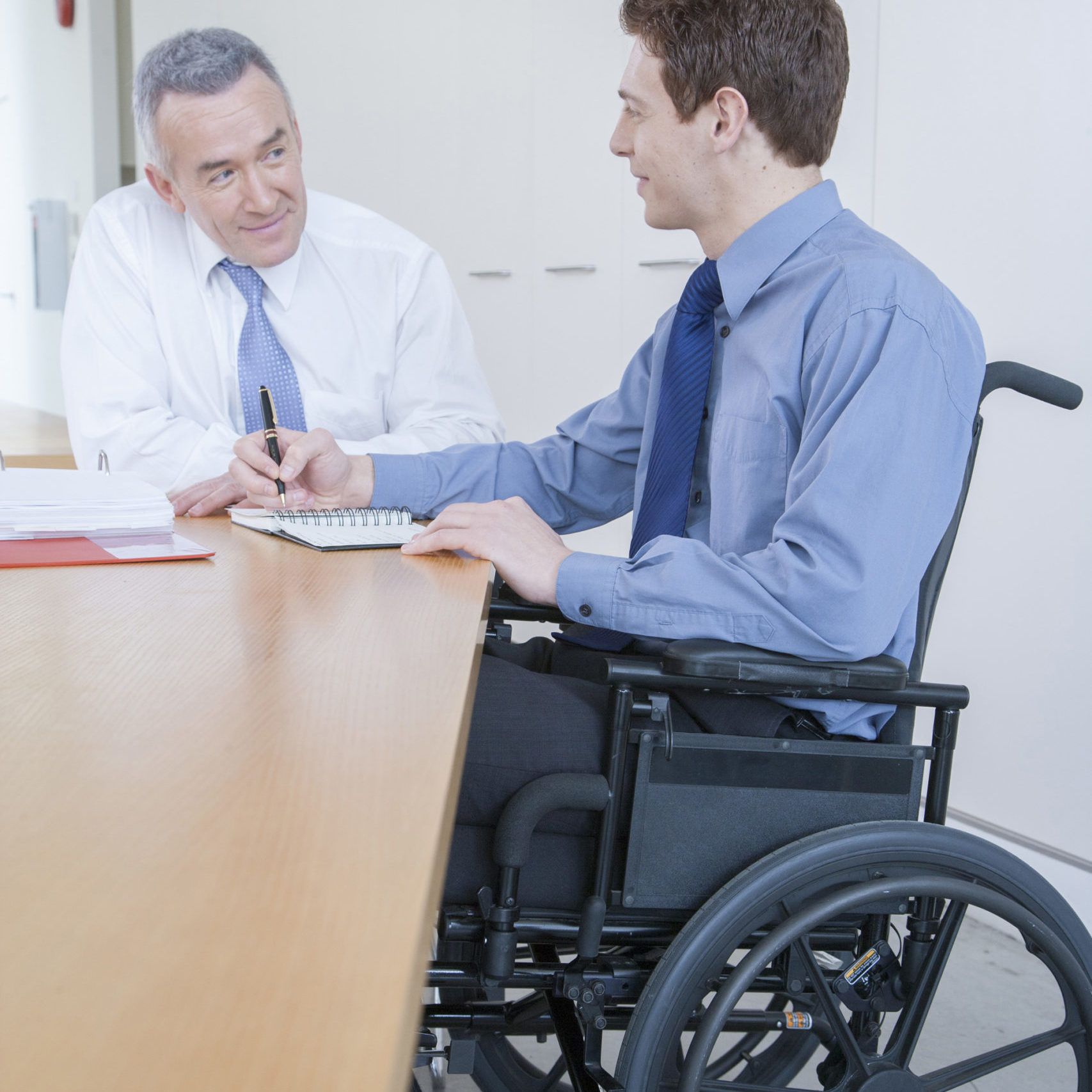 Handicapped man in wheelchair in office